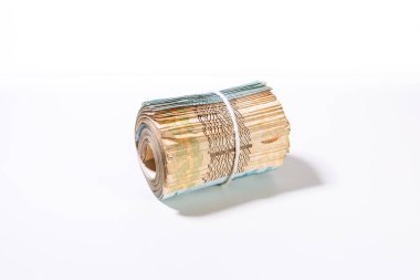 Görünür değer işareti olmadan yalan banknotkalın bir rulo bir dize tarafından bir arada tutulan. Beyaz bir arka plan karşı büyütme aracı ile para temiz stüdyo çekim.