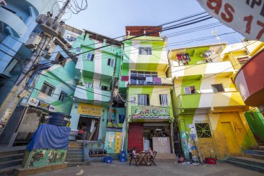 Rio de Janeiro, Brezilya - 30 Aralık 2014: Rio de Janeiro'daki favela Santa Marta'nın (Dona Marta) renkli ana meydanında bir barın önündeki masada oturan iki kız vardı.