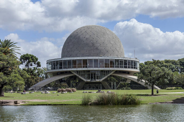 Buenos Aires, Argentina - March 30, 2012: Park view of the planetarium of Buenos Aires, Argentina with a pond in the foreground and clouds in the blue sky