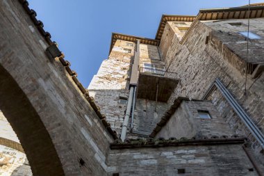 Perugia Ortaçağ tuğla duvar mimarisi, İtalya aşağıdan görülen açık mavi gökyüzüne karşı yükselen