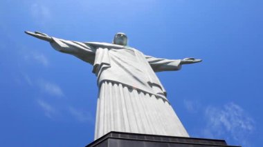 Christ the Redeemer statue in Rio de Janeiro on a bright sunny day with a blue sky seen from under the statue and scaffold