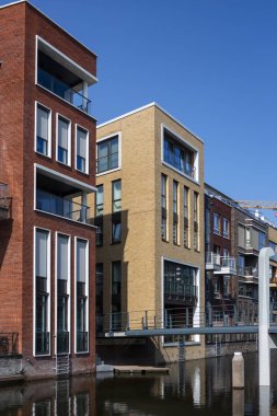 Amsterdam, Hollanda - 31 Ağustos 2019: Yeni inşa edilen Houthaven Mahallesi 'nde arka planda bir vinç ile çağdaş mimari