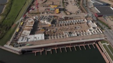 Hollanda 'nın Zutphen kentindeki yeni Noorderhaven semtindeki bir inşaat sahasının hava manzarası, ağır ekipmanlar ve ilk kattaki konut binalarıyla dolu.