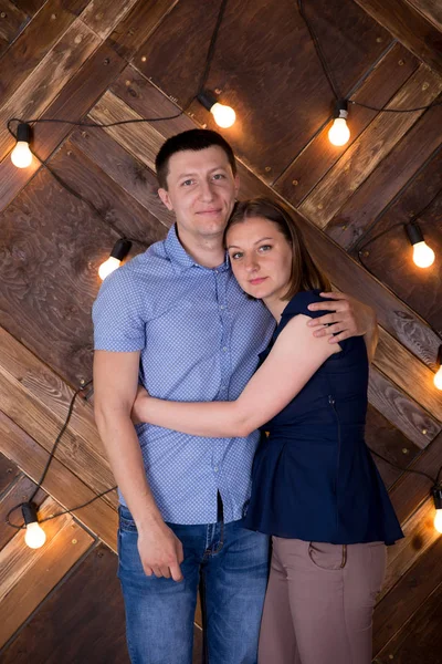 Portrait of Young Couple on Wooden Background — Stock Photo, Image