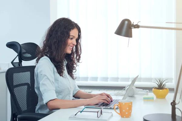 Young pretty business woman with notebook in the office