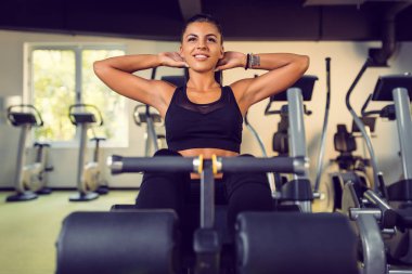 Çekici genç kadının yapması Sit up egzersiz makinesi