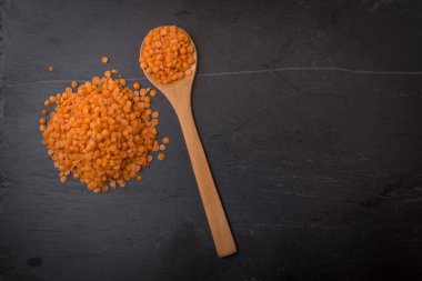 Bir kaşık siyah granit zemin üzerine kırmızı mercimek