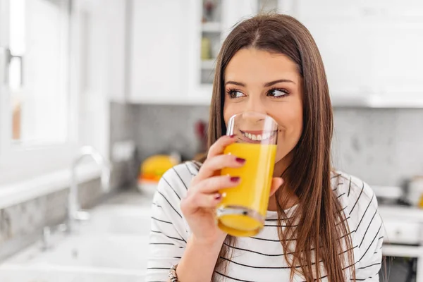 Gros plan d'une adolescente buvant du jus tout en regardant par une fenêtre — Photo