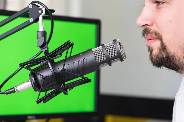 Attractive Young Man speaking Into Microphone. Man and podcast h
