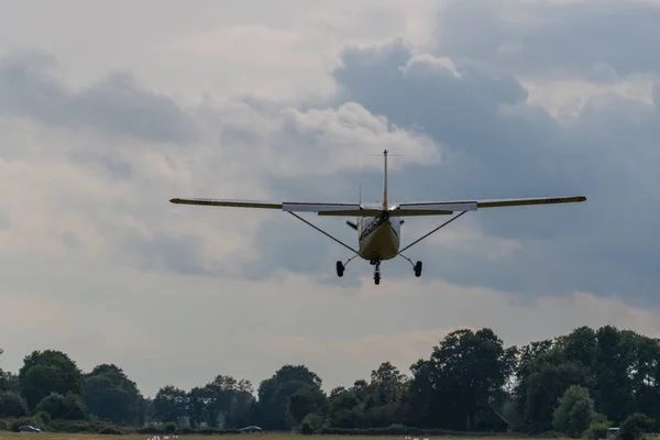 Un avión de aterrizaje sobre un fondo gris — Foto de Stock