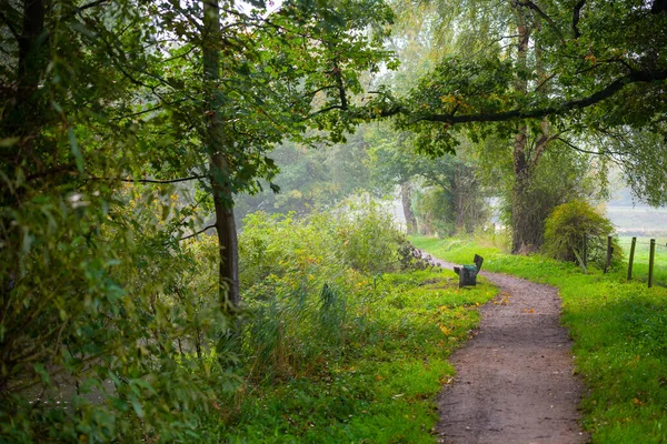 On a rainy day, the sun  comes out near a river — Stock Photo, Image