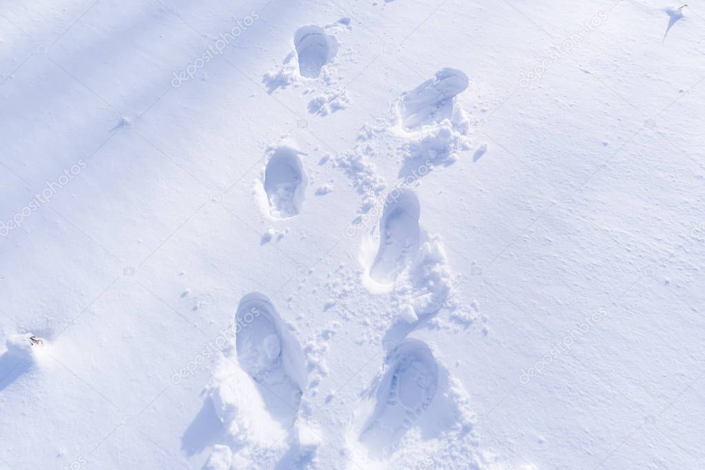 Footprint and hands on snow for texture background
