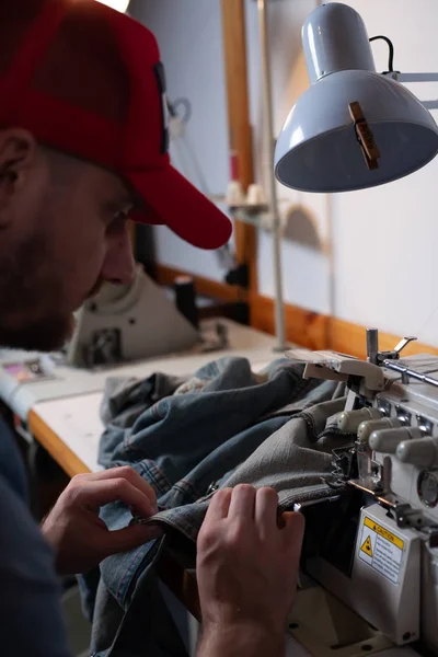 European Man Sews Clothes His Sewing Workshop Home — Stock Photo, Image