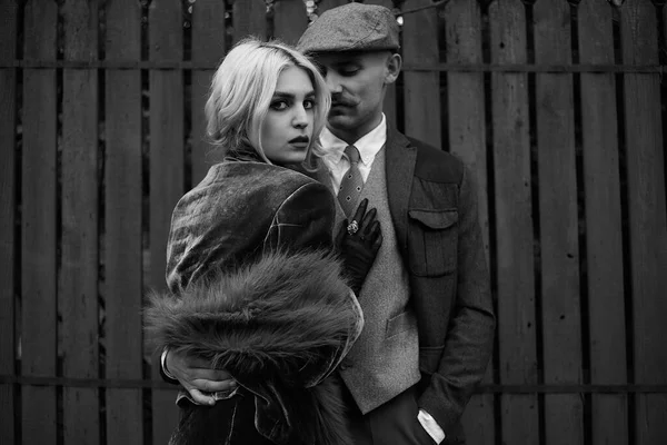 Portrait of a beautiful couple in vintage style. Retro style, classic clothes.