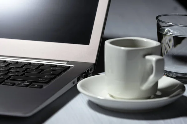 Cup of coffee on table, white cup, office desk, business area, coffee break office