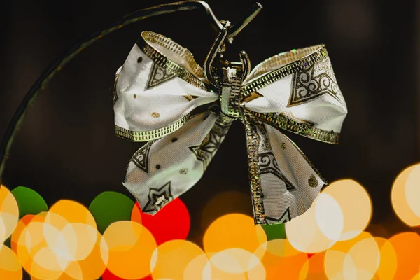 圣诞丝带蝴蝶结与五颜六色的散景背景 圣诞装饰和装饰 — 图库照片