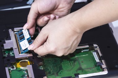 Closeup photo of woman engineer replace computer component, fix pc concept clipart