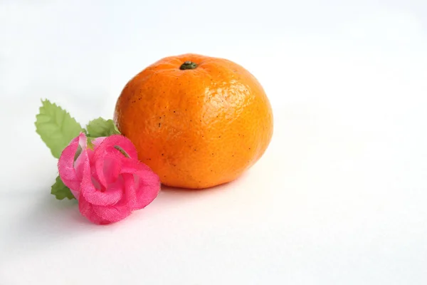 Orange and artificial rose — Stock Photo, Image