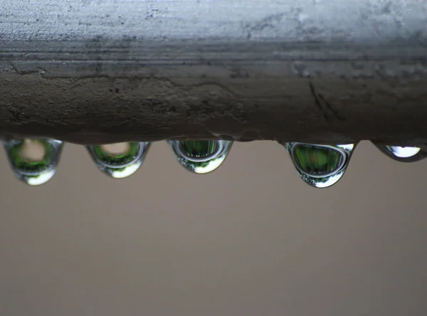 Drops from steel pipe — Stock Photo, Image