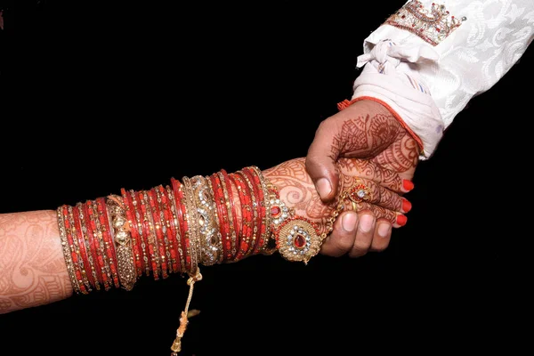 Indian couple Ring ceremony. Indian ritual seen before wedding hand shake together bride with groom. Indian loving couple is getting married. lovely bride hands with mehndi.