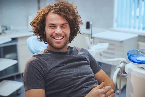 Smiling man with perfect teeth on color background, closeup. Space for text