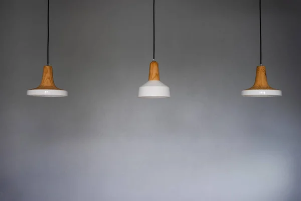 Three white ceramic lamps on the ceiling
