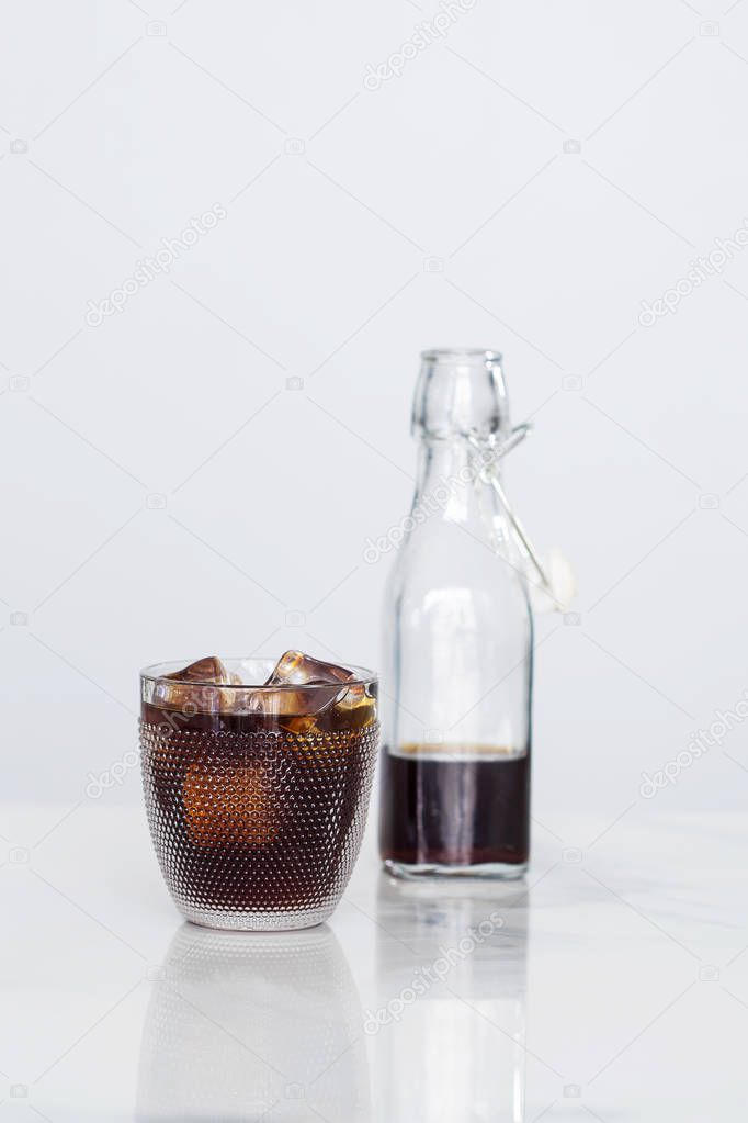 Ice coffee and coffee in a glass bottle