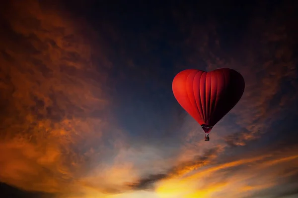 Red hot air balloon in the shape of a heart, Colorful hot-air ba Stock Photo