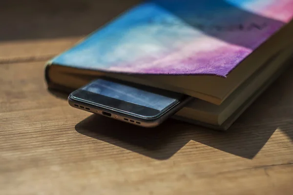 Phone and book on the table