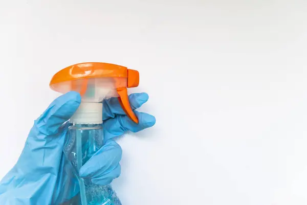 Cleaning agent and gloves on a white background