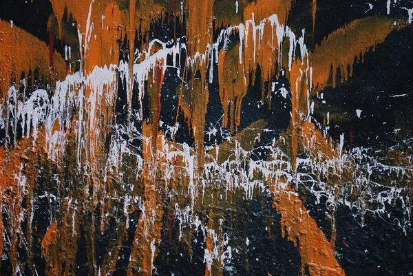 Splashes of white and orange paint on a dark background