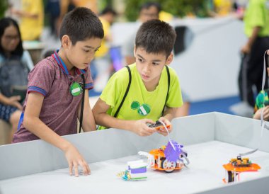 Öğrenci çocuklar oynamak ve sınıf içinde robot kontrol etmeyi öğrenmek