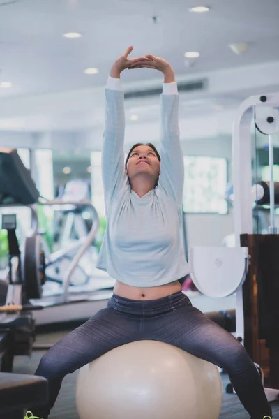 Asian woman work out exercise at Gym weight loss