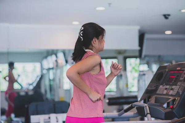 Asian woman work out exercise at Gym weight loss