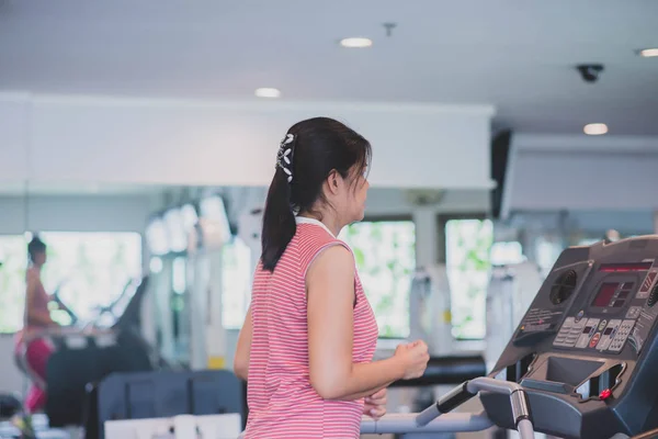 Asian woman work out exercise at Gym weight loss