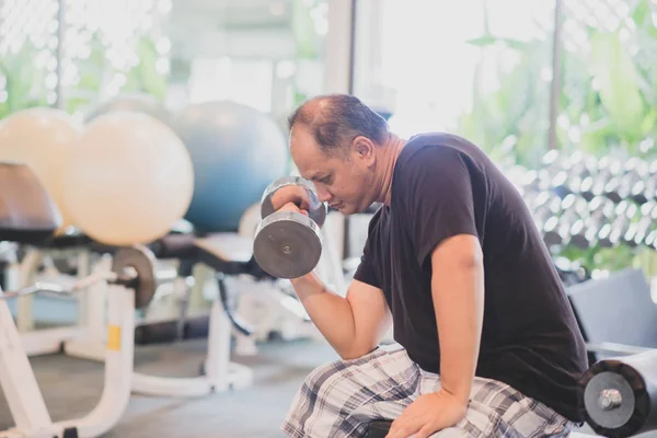 Asian man work out exercise at Gym weight loss