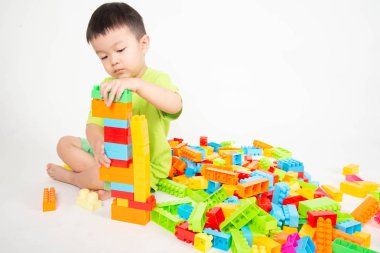 Küçük çocuk küçük çocuk mutlu ile renkli plastik tuğla blok oynarken