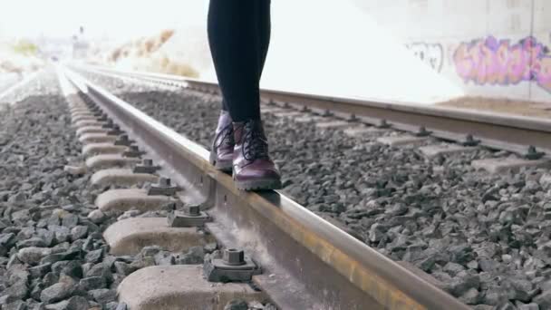 Young Woman Purple Boots Keeps Her Balance Walking Train Tracks — Stock Video