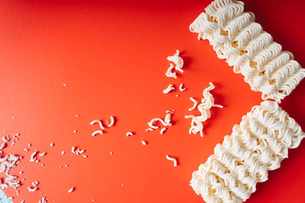 Desmenuzar Fideos Instantáneos Sobre Fondo Rojo — Foto de Stock