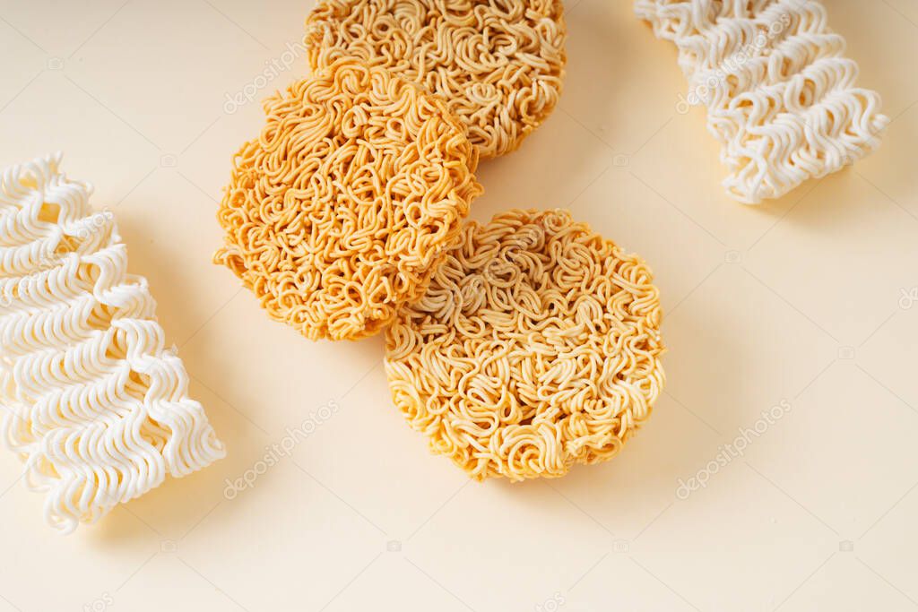 Top view - Many type of instant noodles on plain background. Copy space.