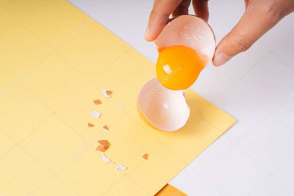 Crack egg with yolk inside. Raw chicken eggs with yolk. Top view.