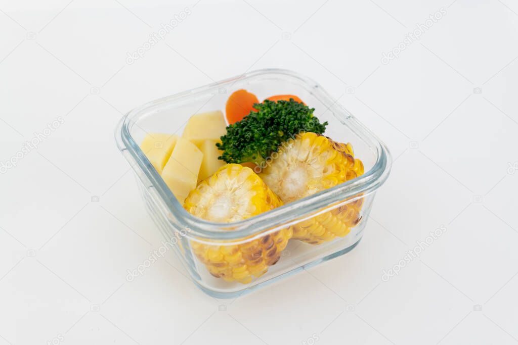 Grill vegetable, corn, potato, carrot, and broccoli in glass bowl. Isolate in white.