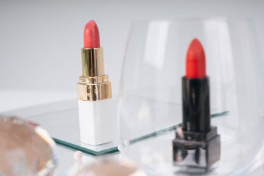 Altın rengi kırmızı ve pembe ruj ve ayna masasında siyah sürgü. Siyah olan cam kaseyle kaplanmış. Kozmetik konteynır. Lüks ruj..