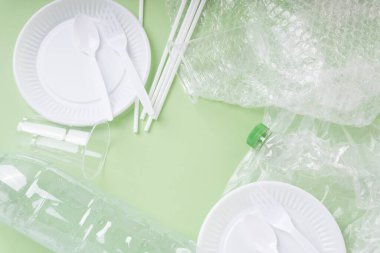 Üst Görünüm - Yeşil arkaplan üzerindeki plastik atık.