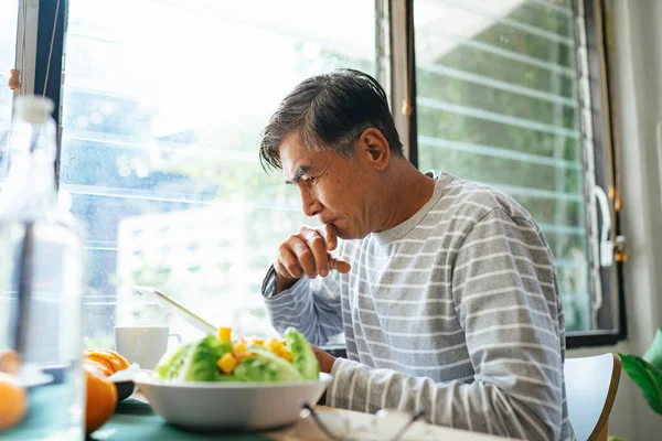 Serious Old Man Reading News Internet Tablet While Has Breakfast — Stock Photo, Image