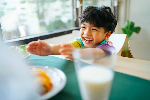 Little Boy Reach His Hands Out Grab Sausage Croissant Table — Stock Photo, Image