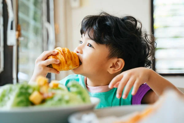 Little Boy Bite Eat Sausage Croissant Deliciously His Breakfast Kitchen — Stock Photo, Image