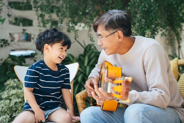 Velho Com Cabelo Grisalho Toca Guitarra Enquanto Seu Neto Canta — Fotografia de Stock