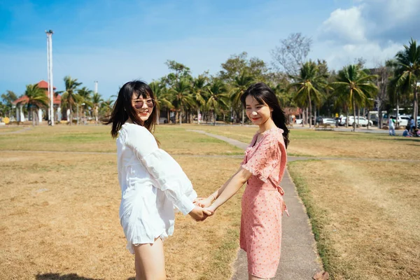 Dwie Dziewczyny Trzymają Się Ręce Podczas Spaceru Zabawy Polu Trawy — Zdjęcie stockowe