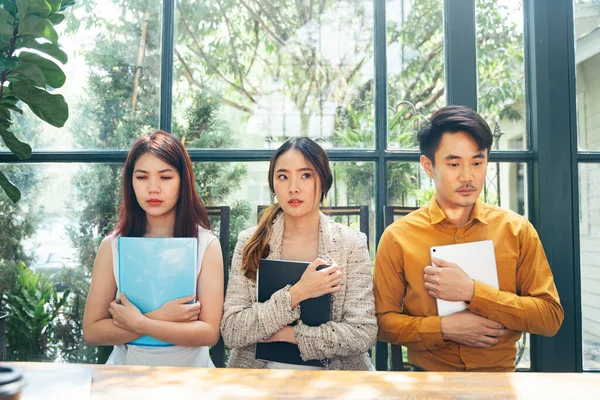 Worried and nervous candidates came in for an interview and waiting for solution. sitting in queue with their cv at office expecting their turn for interview.